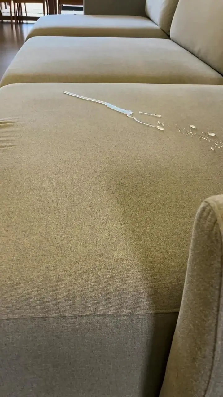 Gotas de água paradas sobre sofá bege impermeabilizado pela JClean